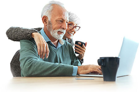 elderly couple looking at laptop